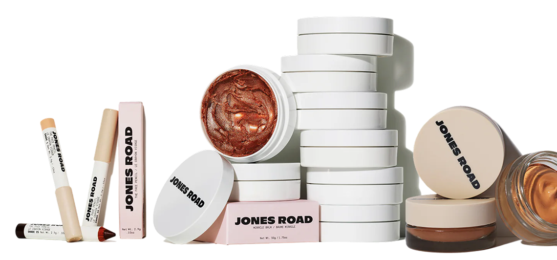 Stack of white cosmetic containers with 'Jones Road' branding.