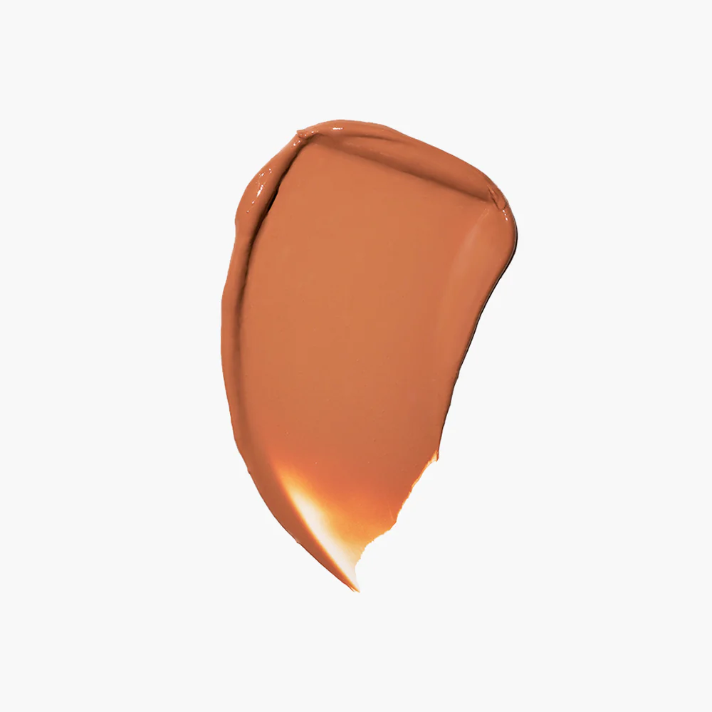 A smear of brown cosmetic product on a white background.