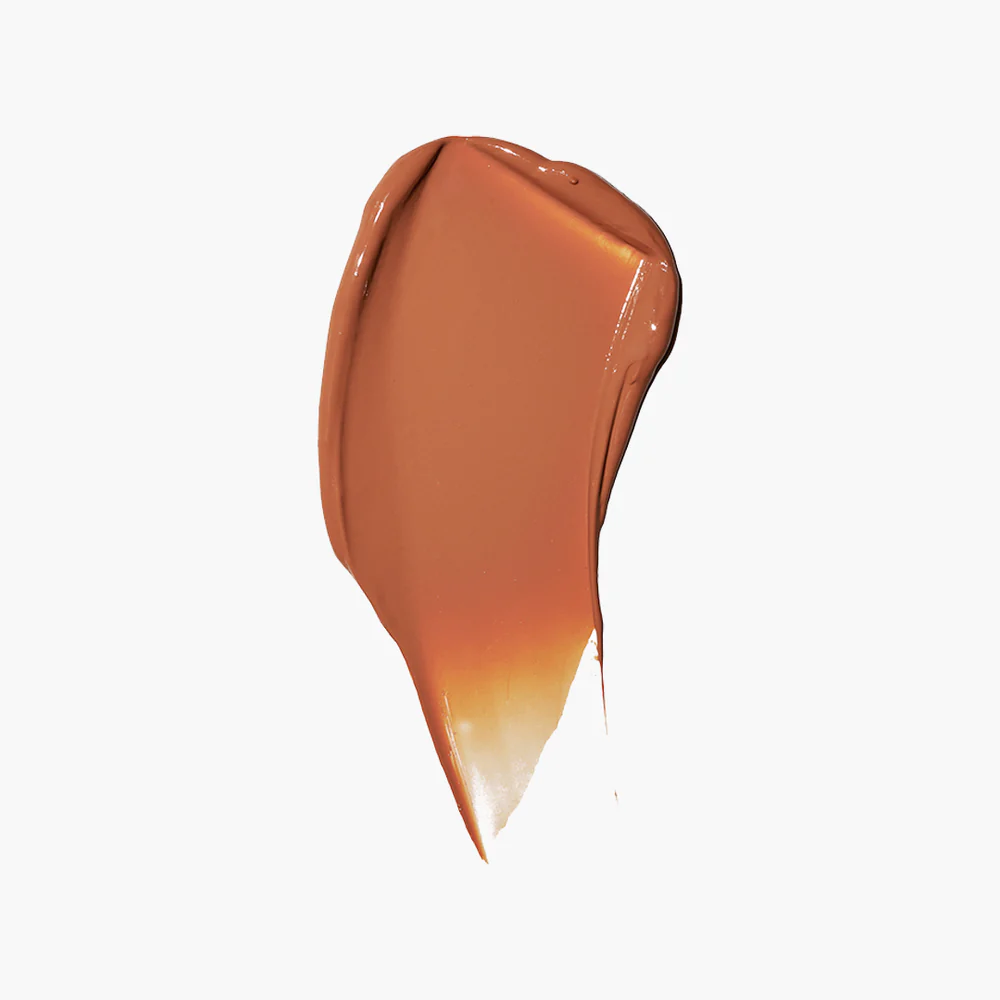 A smear of brown makeup on a white background.