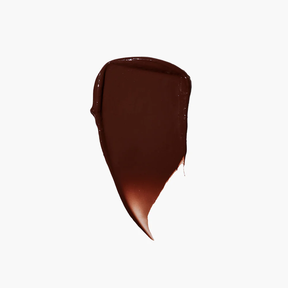 A smear of dark brown substance on a white background.