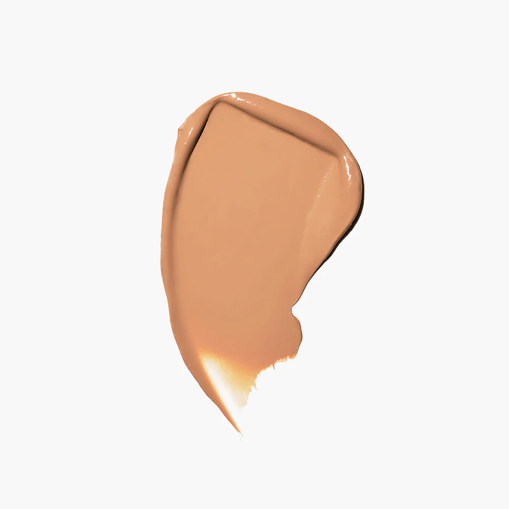 A smear of beige makeup on a white background.