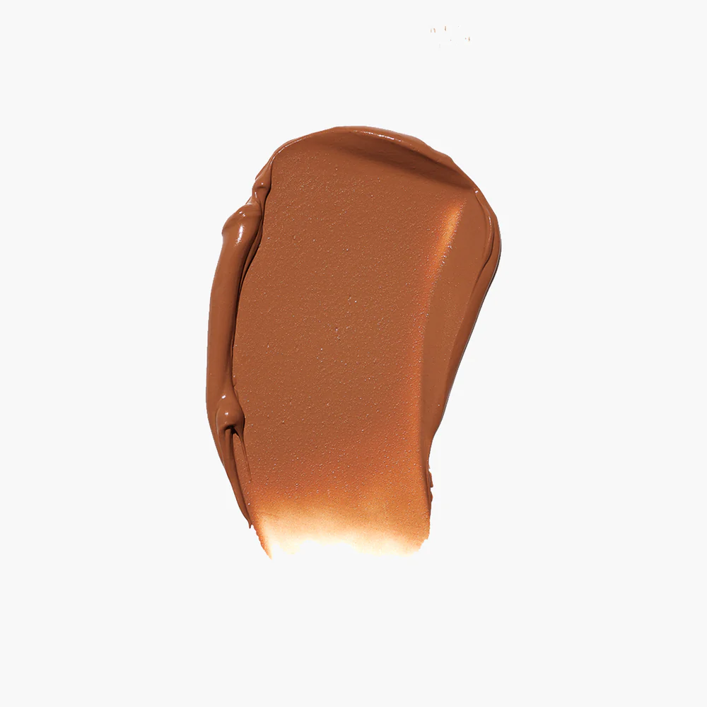 A smear of brown makeup on a white background.