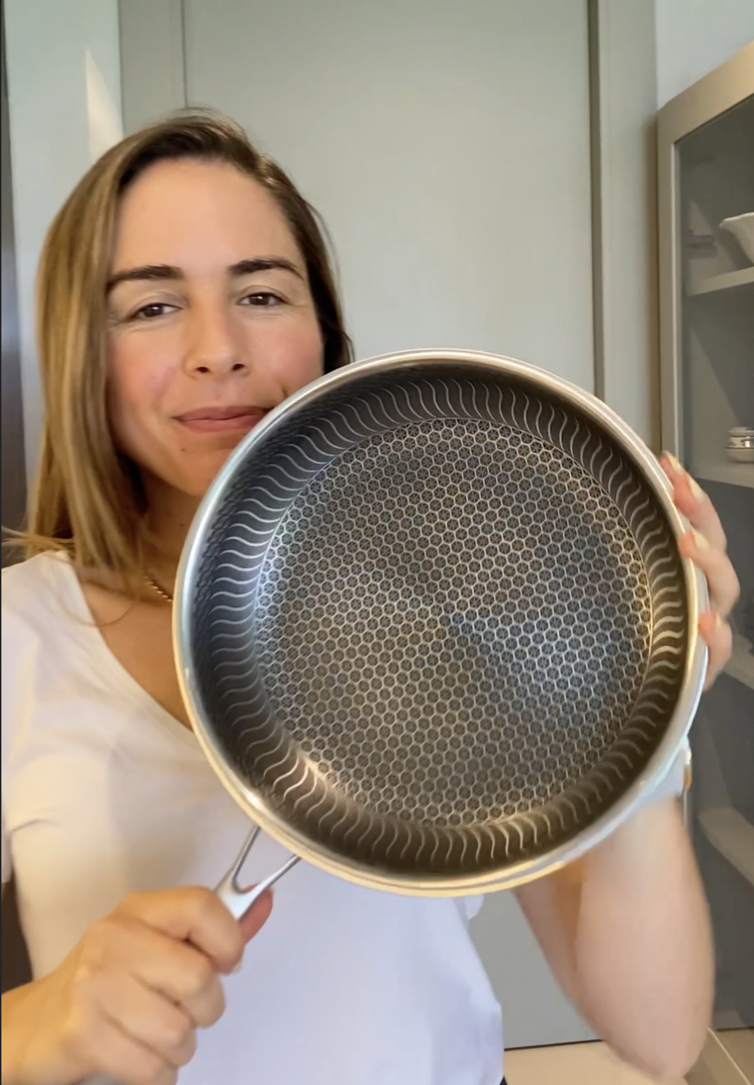 Person holding a frying pan with a textured interior.