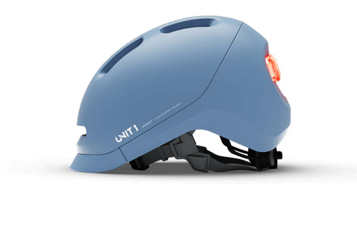 Blue bicycle helmet with rear light and ventilation holes.