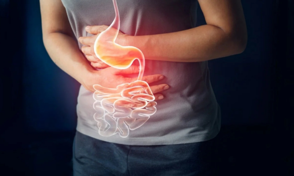 Person holding their stomach with both hands.
