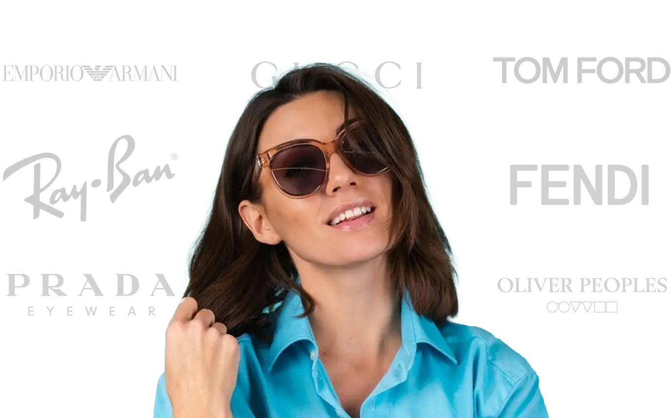 A woman in a blue shirt wearing sunglasses smiles confidently.