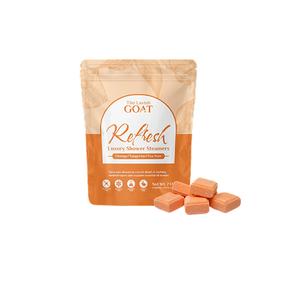 Orange shower steamers and packaging on a white background.