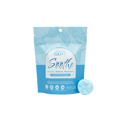 Blue packaging of luxury shower steamers with a round steamer beside it.