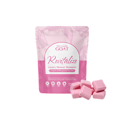 Pink shower steamer package with several pink cubes beside it.