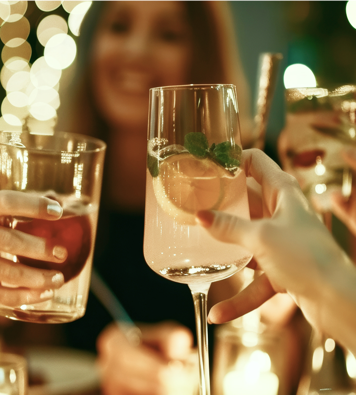 People toasting with drinks at a festive gathering.