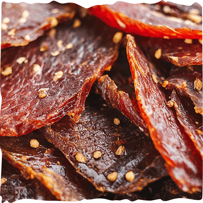 Close-up of seasoned beef jerky slices.