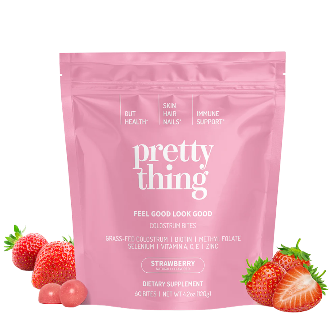 Pink package of dietary supplement with strawberries and text about health benefits.