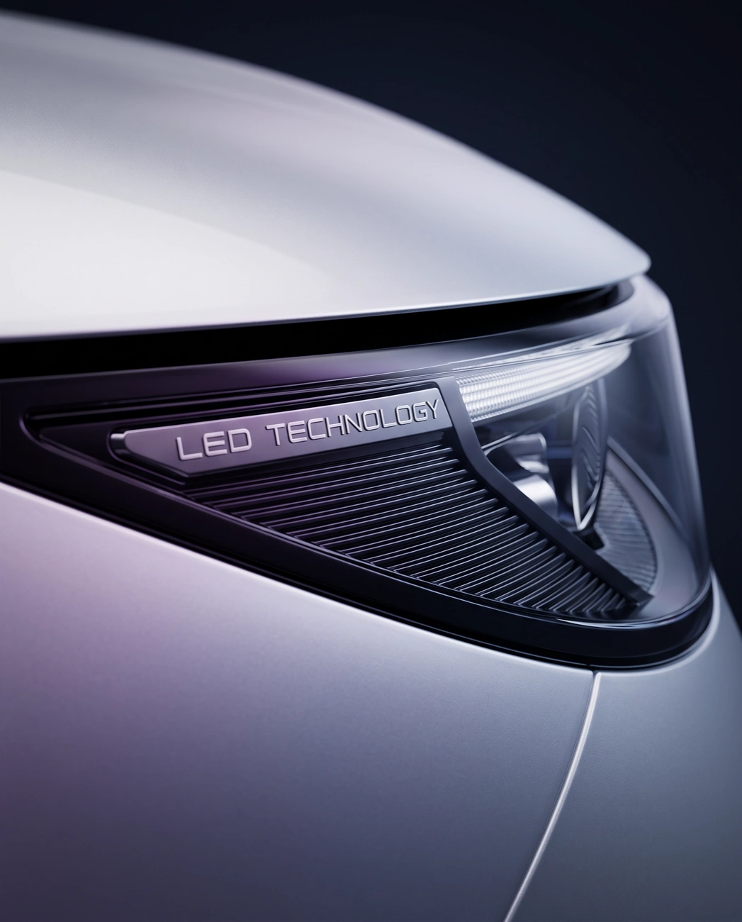 A close-up shot of a modern car's headlight which has the words 'LED TECHNOLOGY' printed on it.