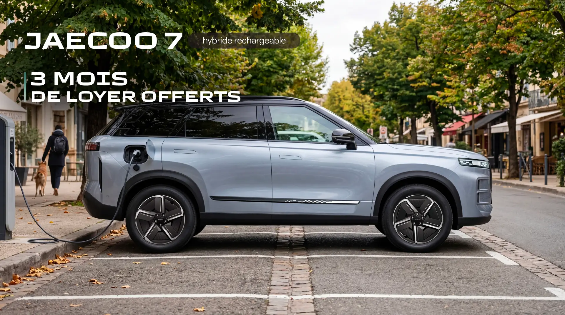 A light blue Jaecoo 7 hybrid SUV plugged into a charging station on a city street.