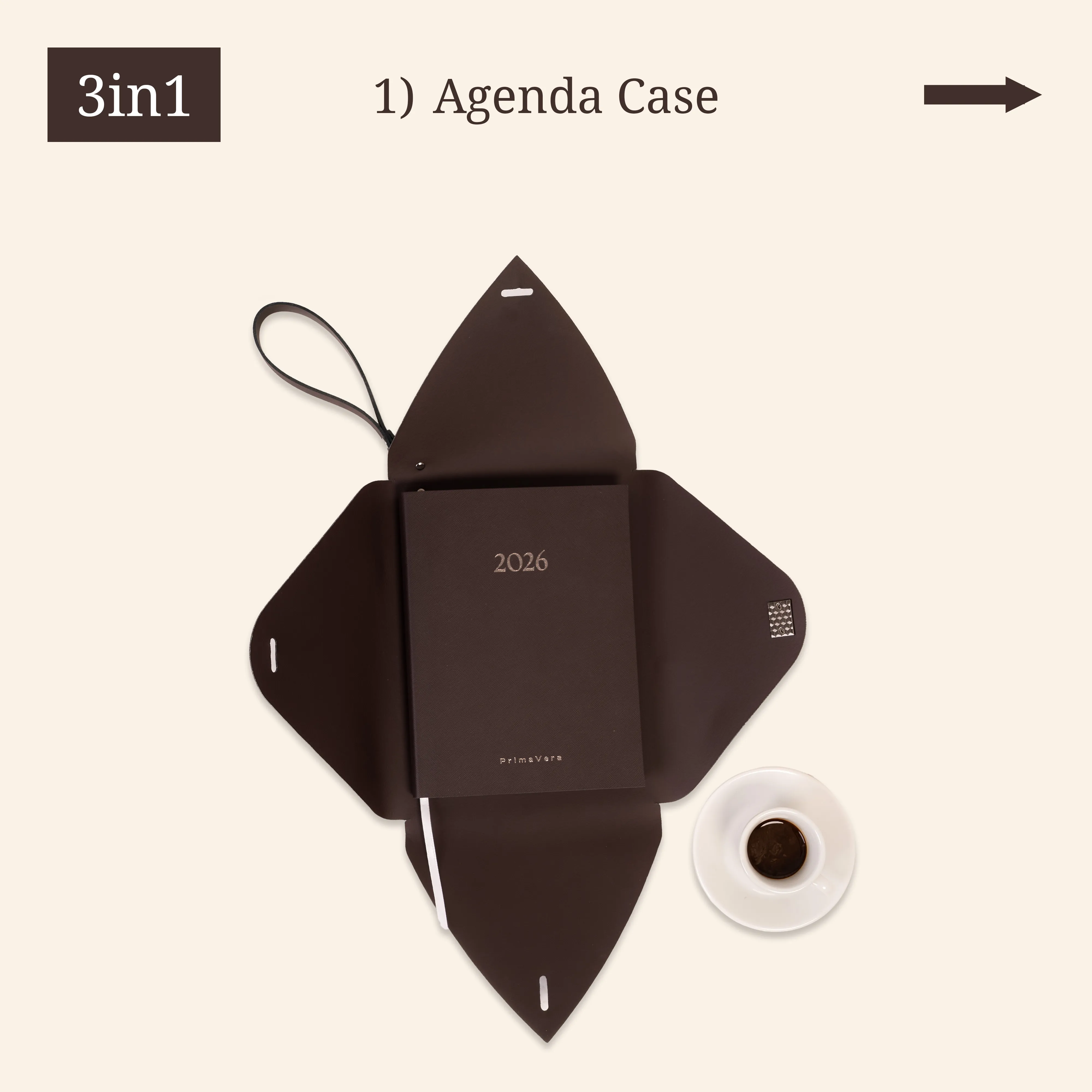 Open brown agenda case with a 2026 agenda and a small espresso cup.