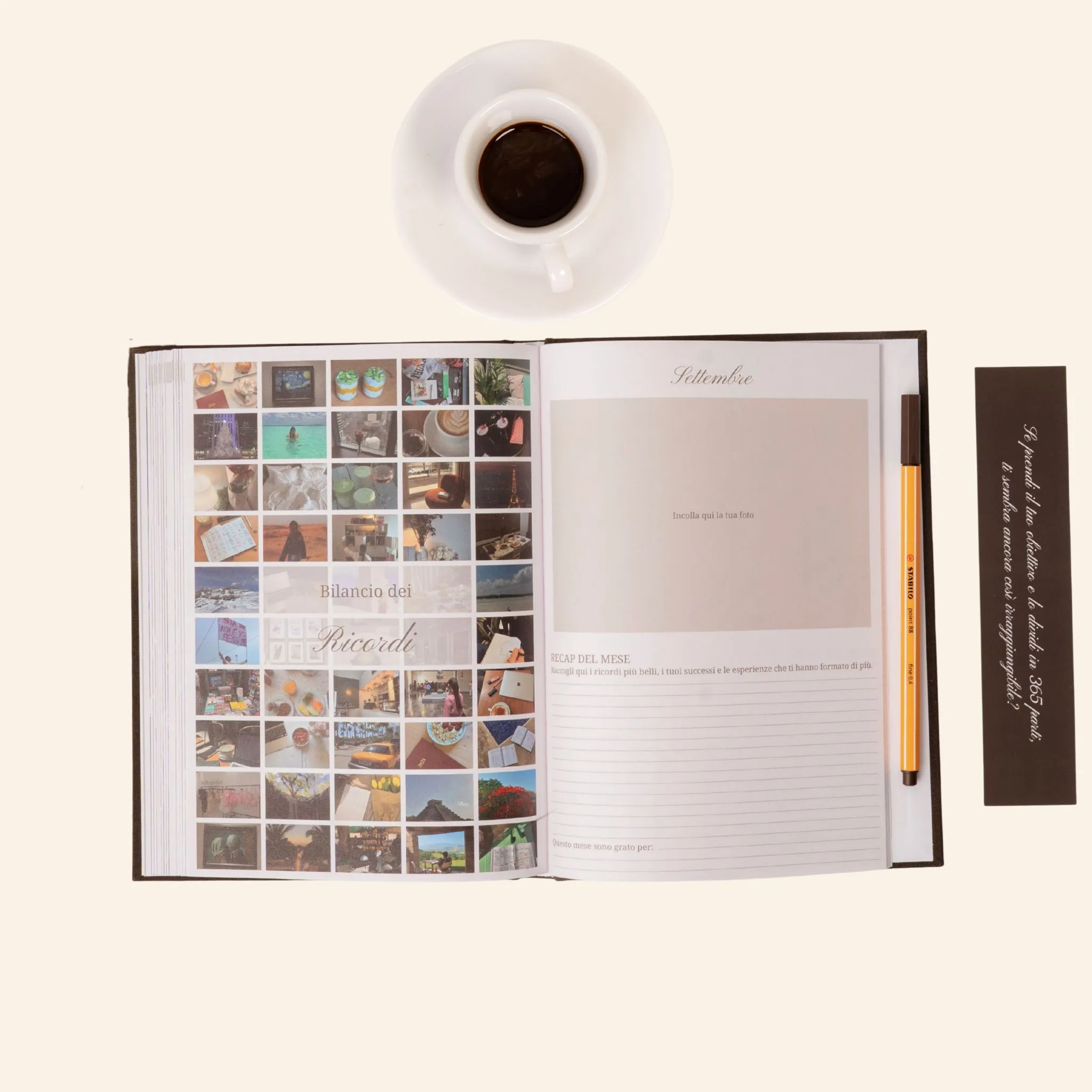 Open journal with photos, a pen, coffee cup, and bookmark on a light background.