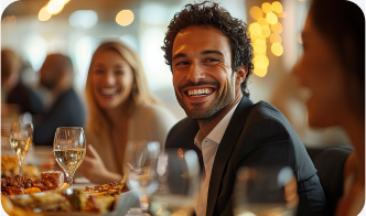 A group of people laughing and dining at a restaurant.