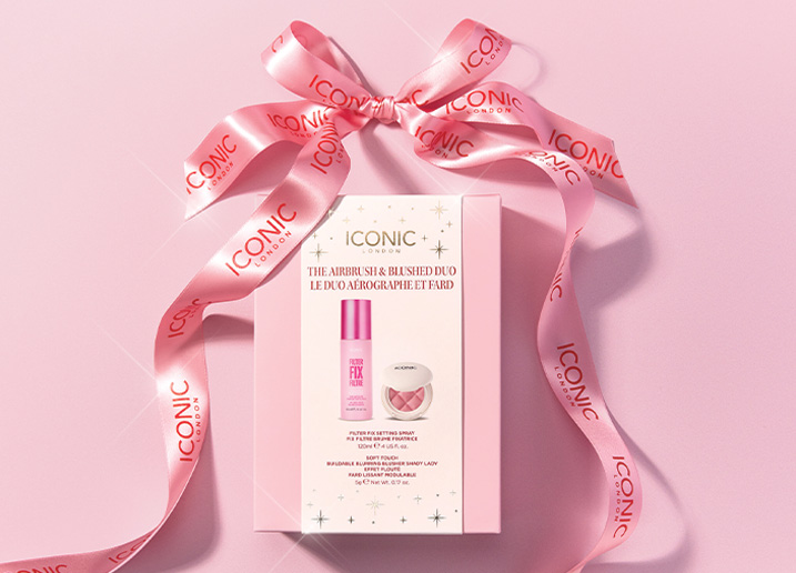 An Iconic London makeup gift set in a pink box, tied with a branded pink ribbon bow.