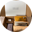 An open cardboard box with several neatly packed smaller packages and a card inside.