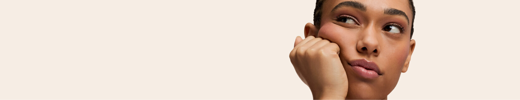 Person resting chin on fist, looking sideways.