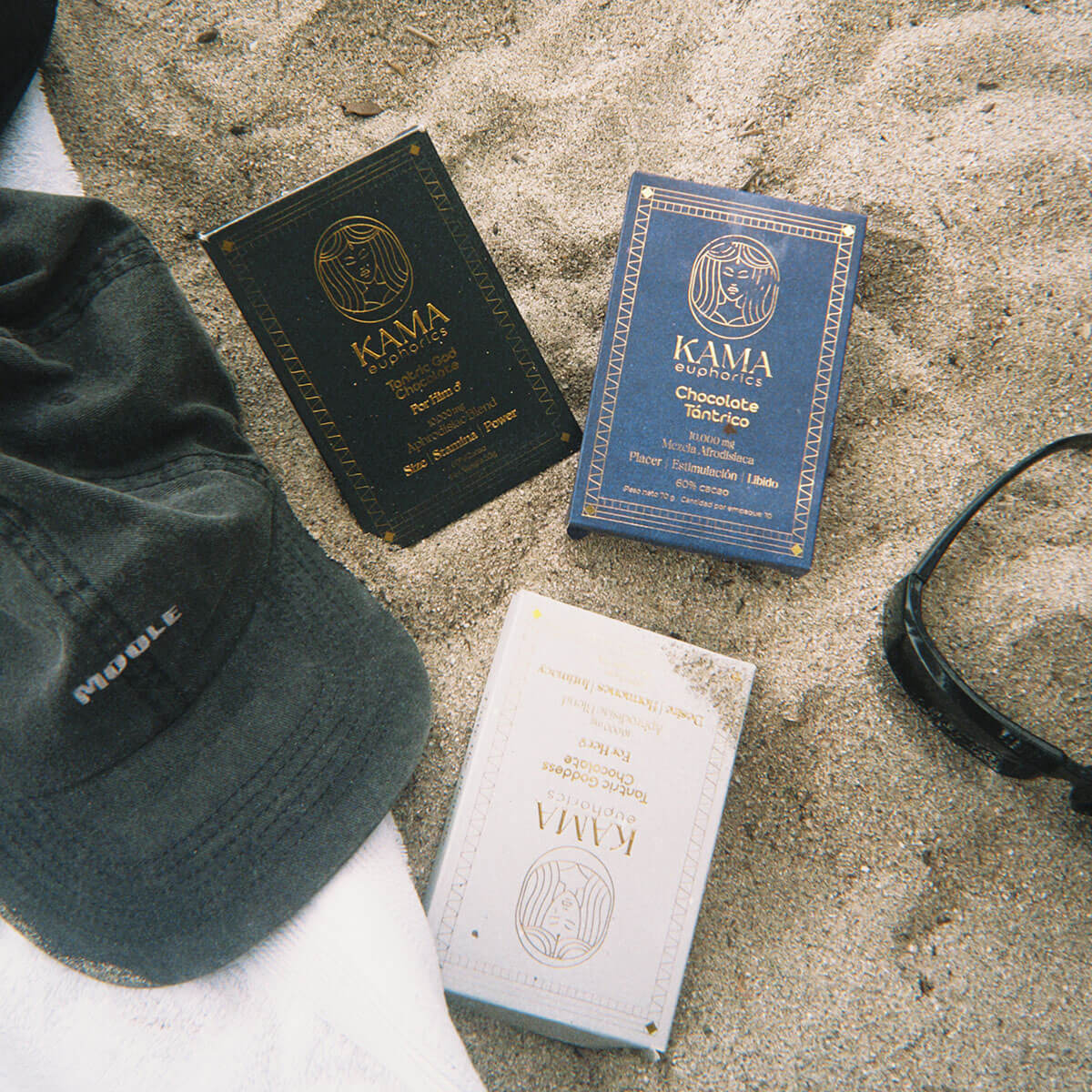Three packages of Kama euphorics chocolate with a chocolate bar.