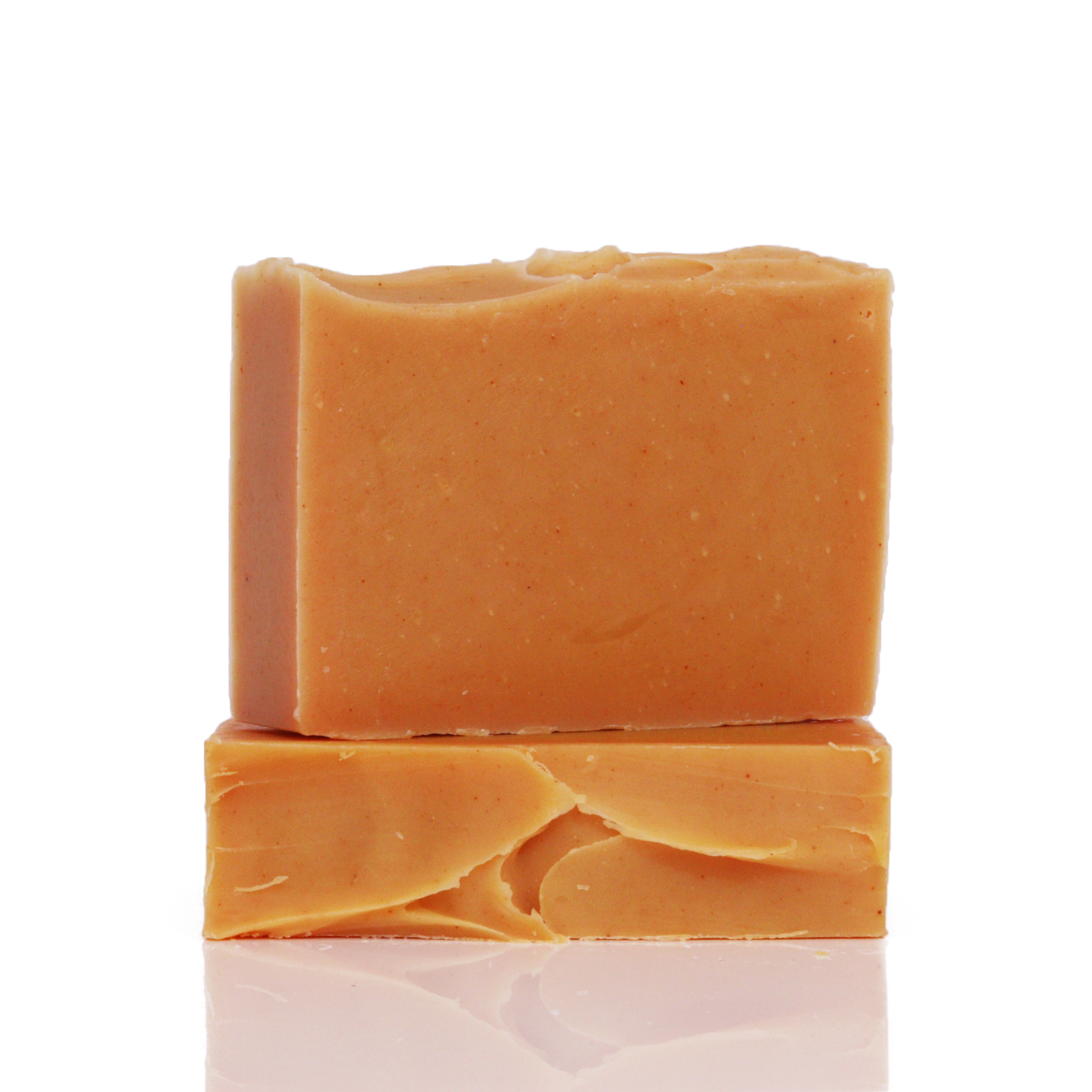 Two stacked bars of orange soap on a white background.