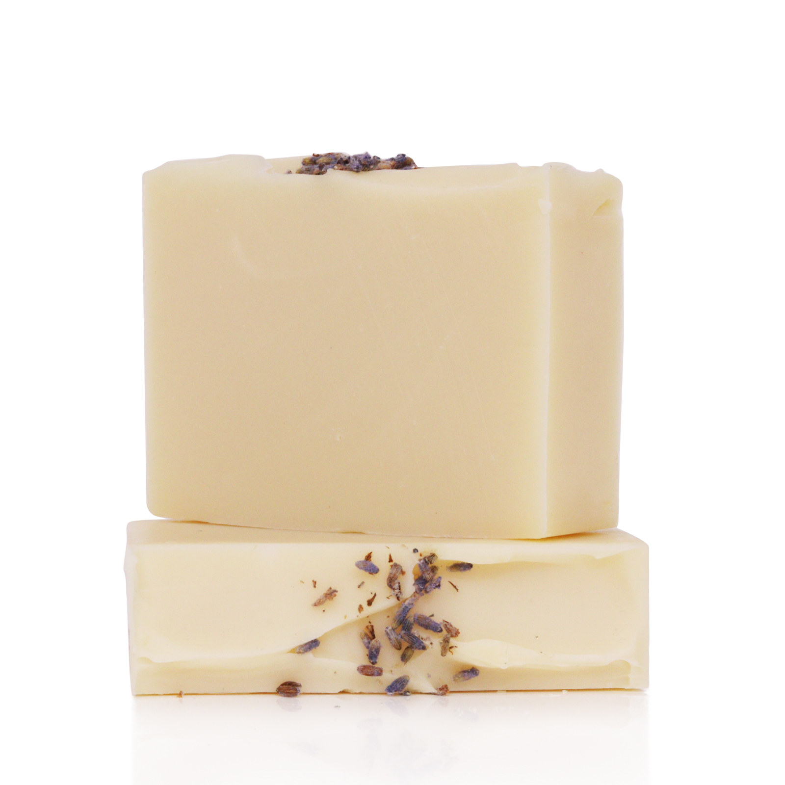 Two beige soap bars with dried lavender on top.
