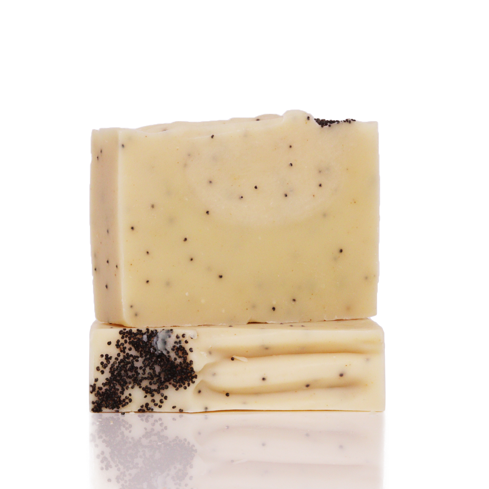 Two stacked soap bars with small black specks on a white background.