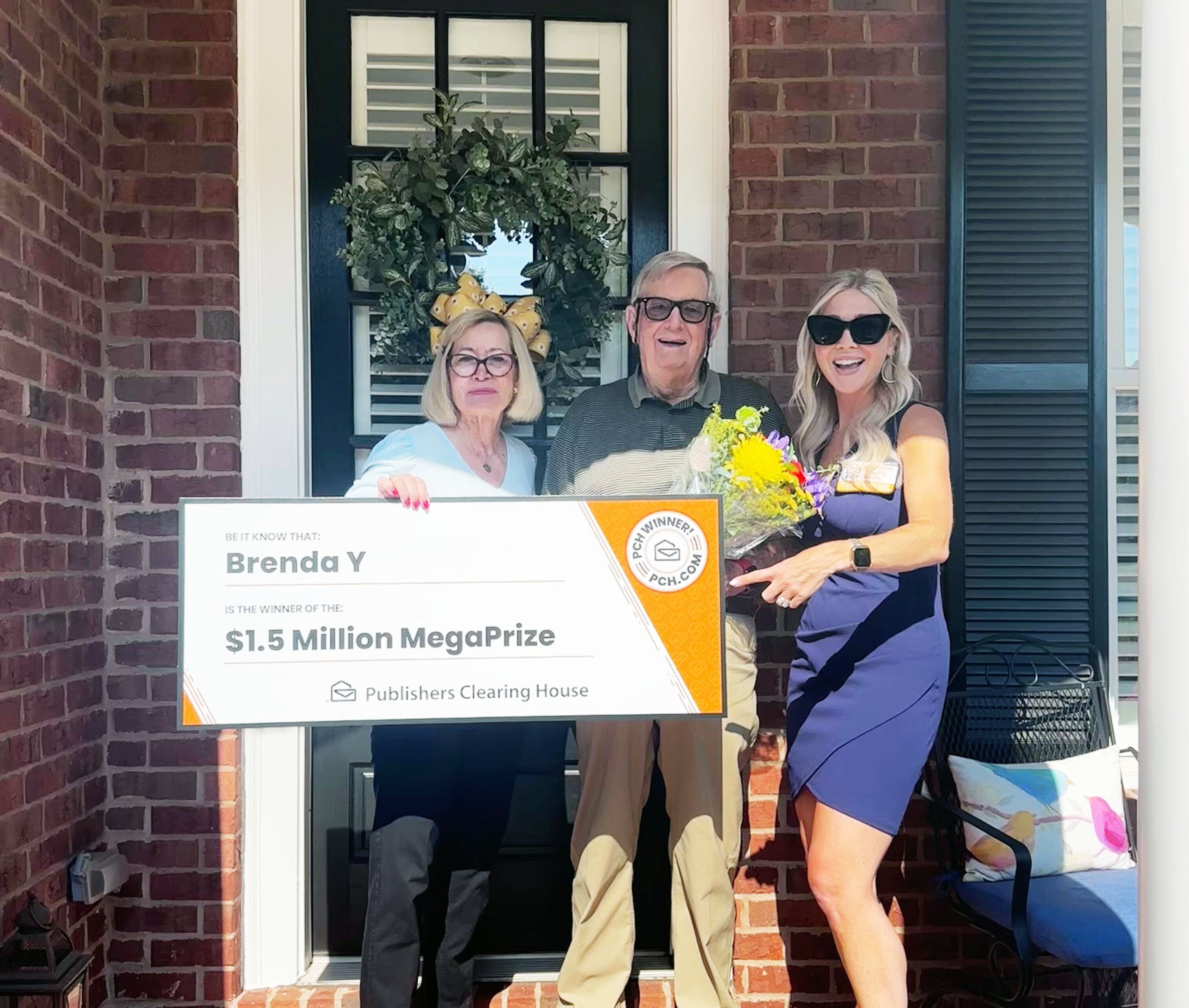 A couple and a PCH representative pose with a giant check for $1.5 million.