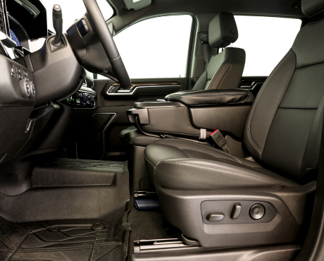 The interior of a modern truck, showing the driver's seat, steering wheel, and center console.