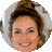A low-resolution, octagonal headshot of a smiling woman with her brown hair in a bun.