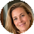 A circular headshot of a smiling woman with blonde hair.