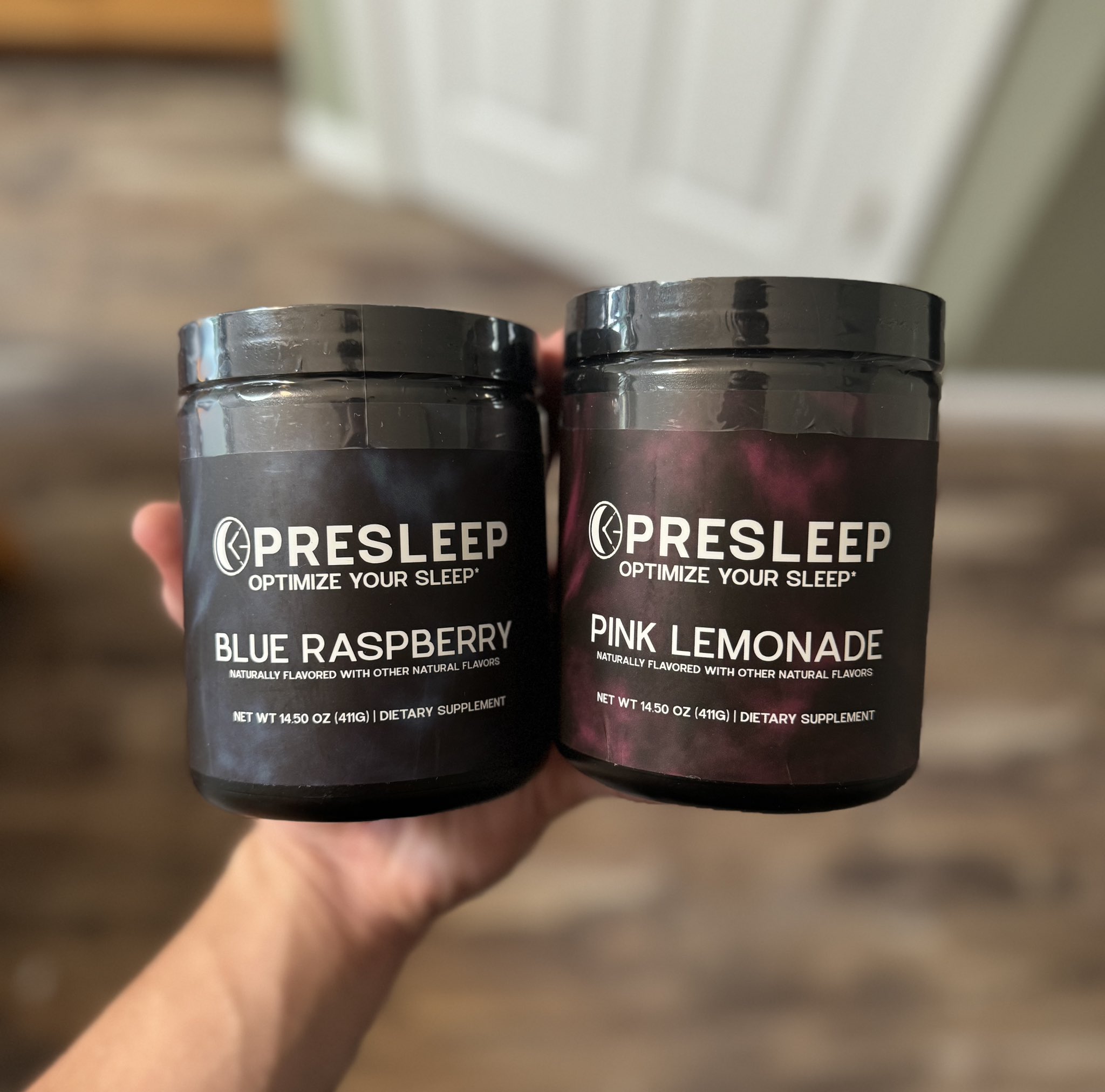 Two jars of Presleep supplement in Blue Raspberry and Pink Lemonade flavors.