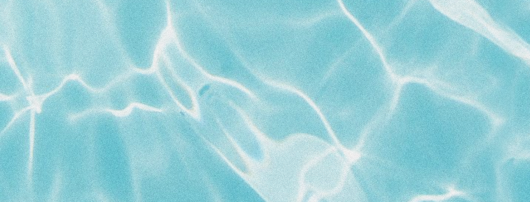 Abstract pattern of light reflections on a blue water surface.