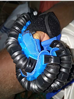 Close-up of a person holding a blue and black flexible tubing device.