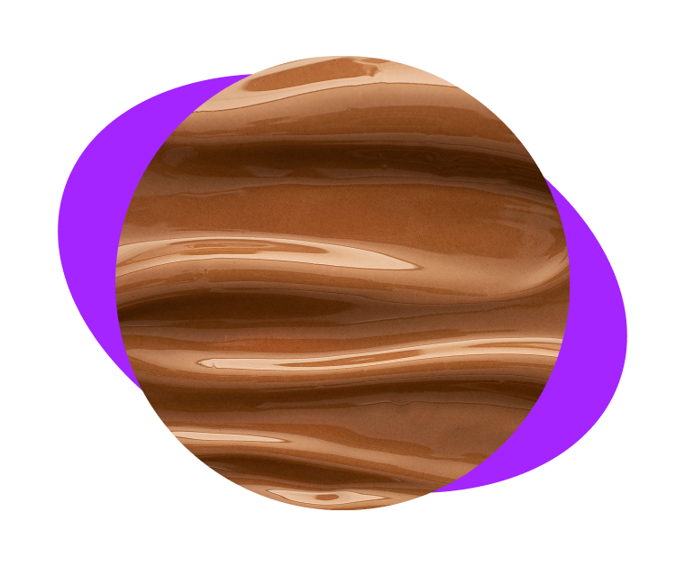 A close-up circular swatch of swirled, glossy brown liquid makeup against a purple and black background.