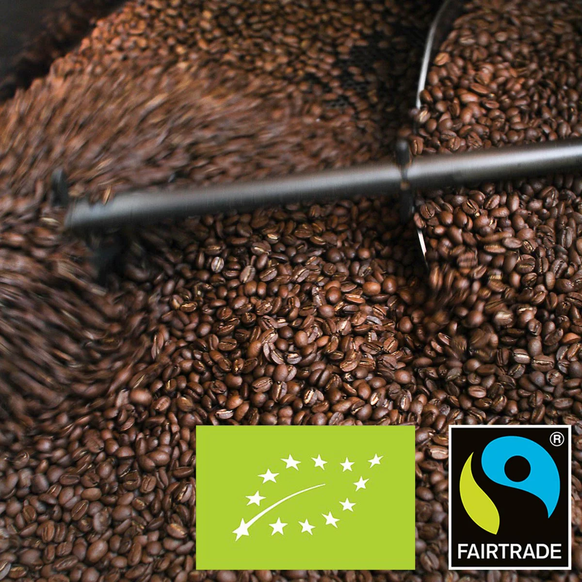 Roasting coffee beans with organic and Fairtrade logos.