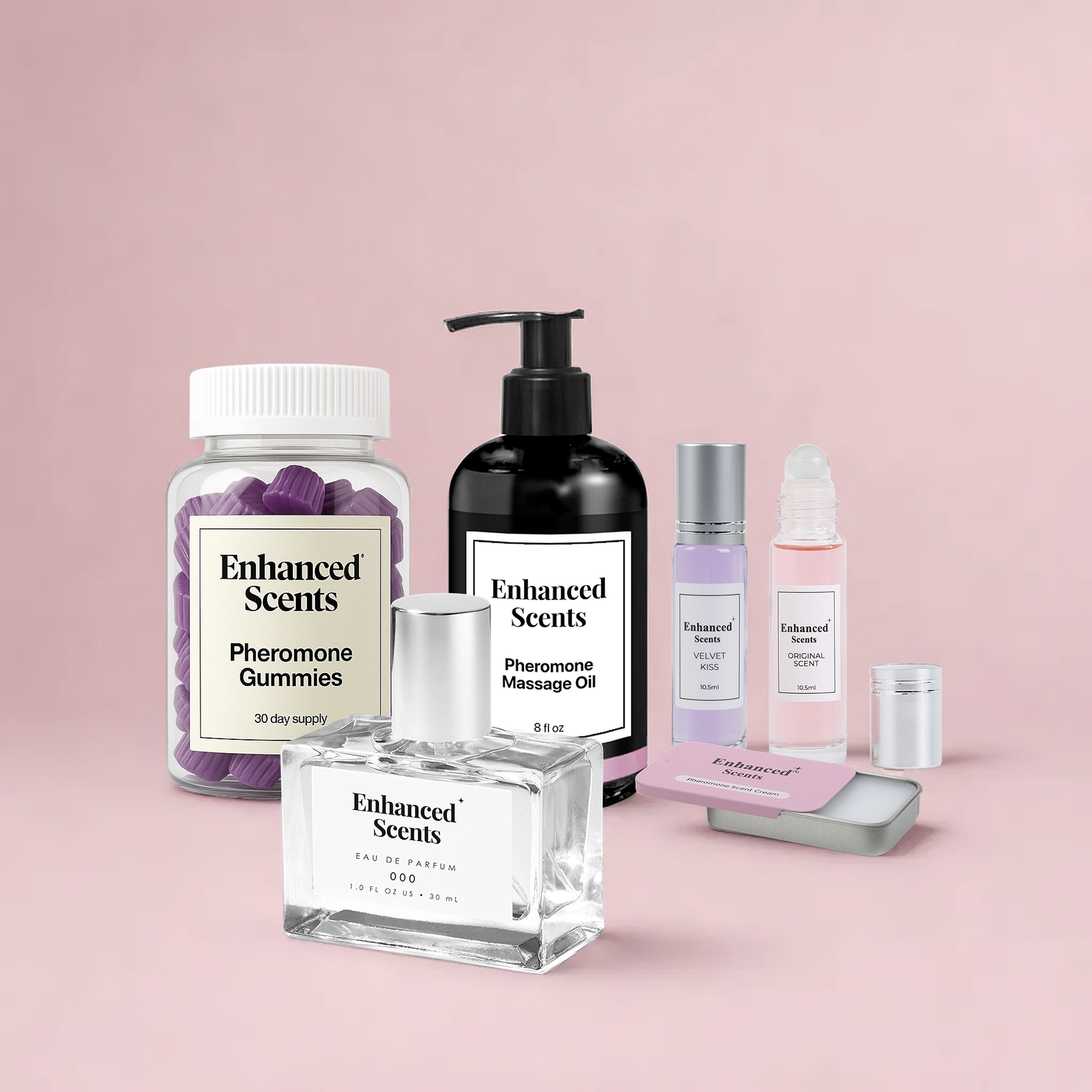 Collection of Enhanced Scents products including gummies, massage oil, and perfumes on a pink background.