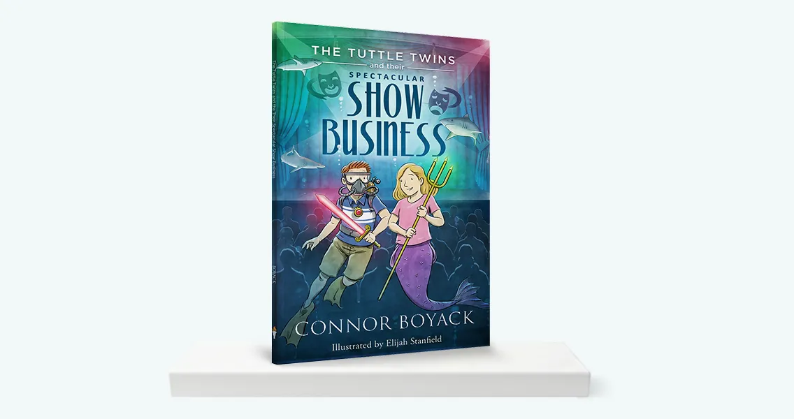 The book 'The Tuttle Twins and their Spectacular Show Business' standing upright on a white shelf.
