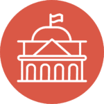 A white line icon of a government building with a flag, set against a circular red background.