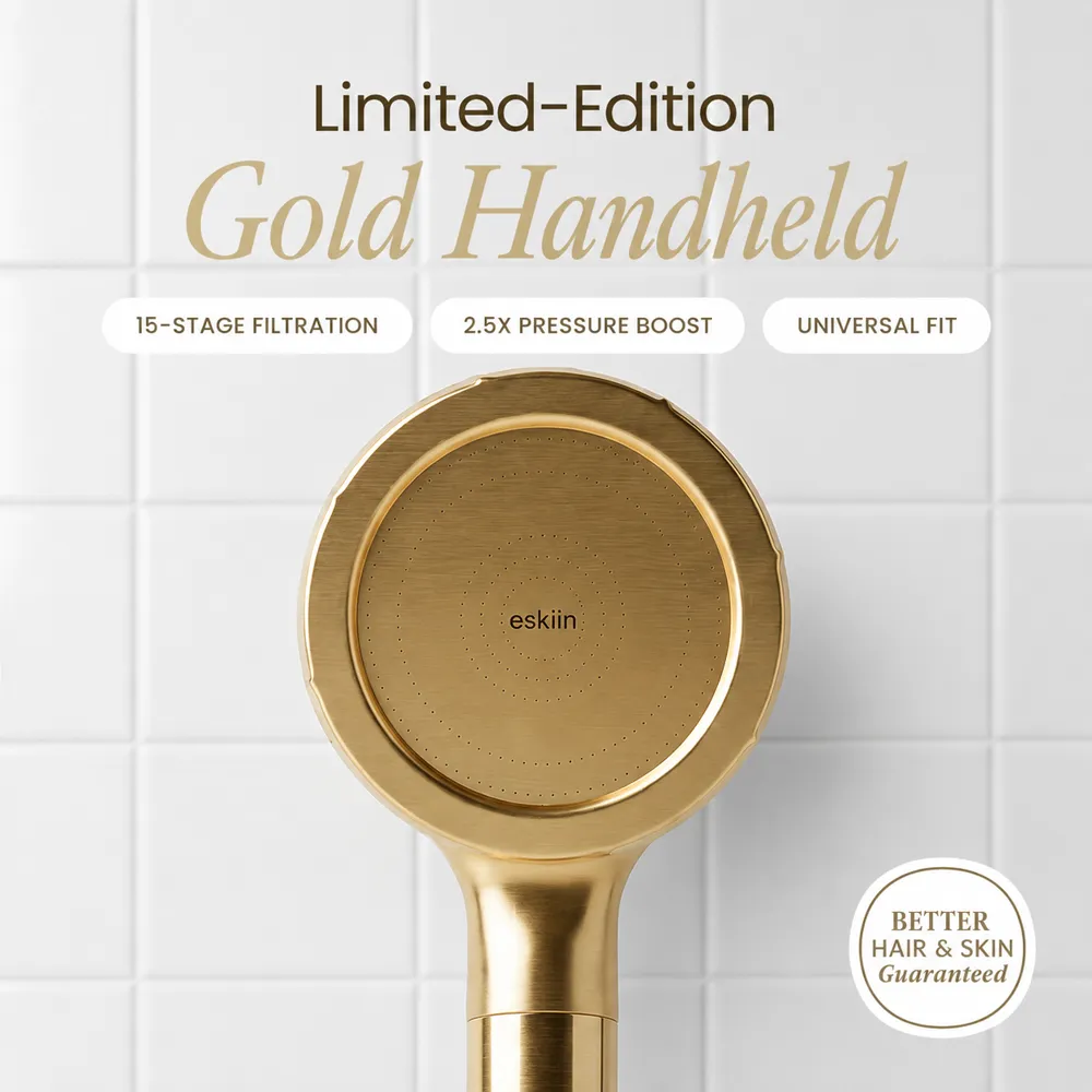 An advertisement showing a close-up of a limited-edition gold handheld shower head against a white tile background.