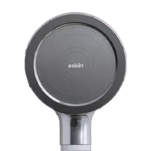 A close-up, front-facing view of a round, silver shower head with the brand name 'eskiin' on it.
