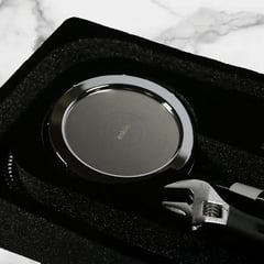 Chrome handheld showerhead in its packaging with an installation tool