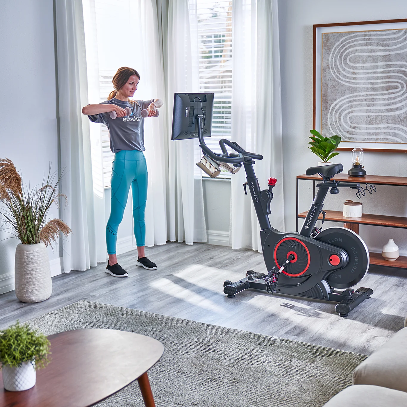 Person exercising at home with a stationary bike and screen.