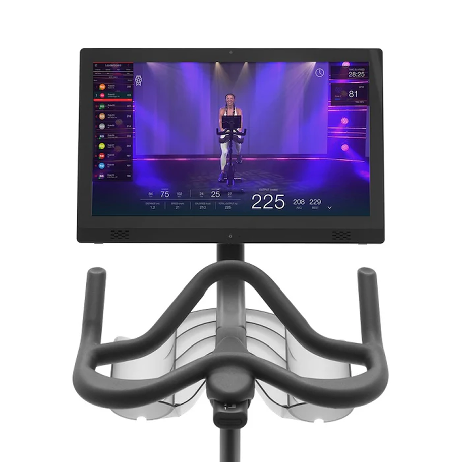 Exercise bike screen showing virtual cycling class with instructor.