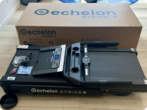 Folded treadmill with accessories in front of original packaging box.