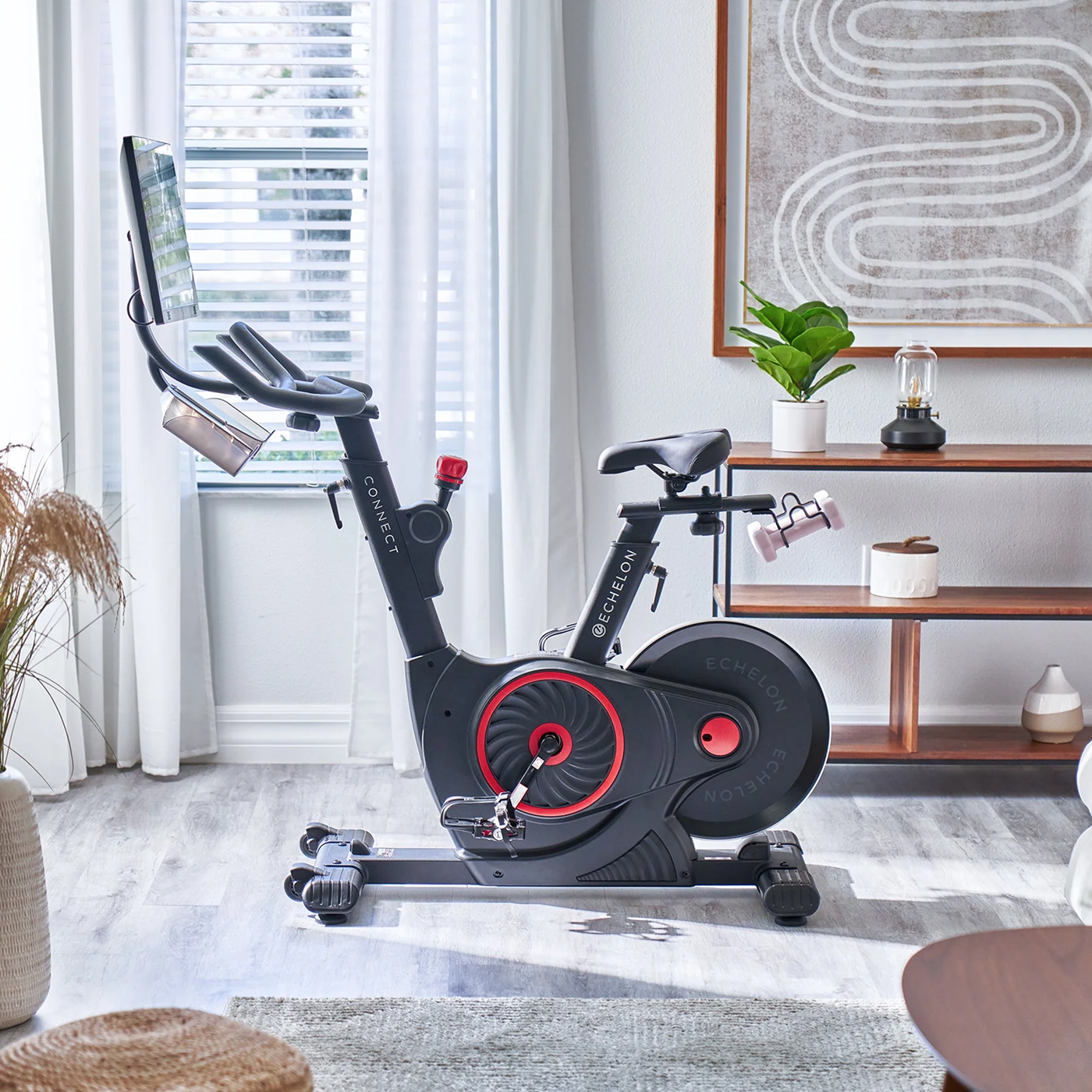 Stationary exercise bike in a bright room with modern decor.