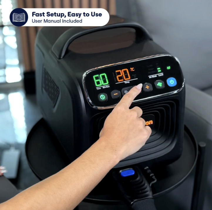 A person's hand pressing a button on the digital control panel of a black portable appliance.