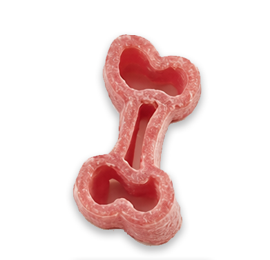 Close-up of pink bone-shaped pasta showcasing its hollow shape on a plain background