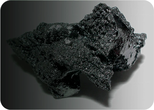 Black, glossy volcanic rock with a rough, porous texture.